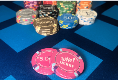 Poker chip values and colors showing standard casino chip denominations and a pink win derby chip for $5,000
